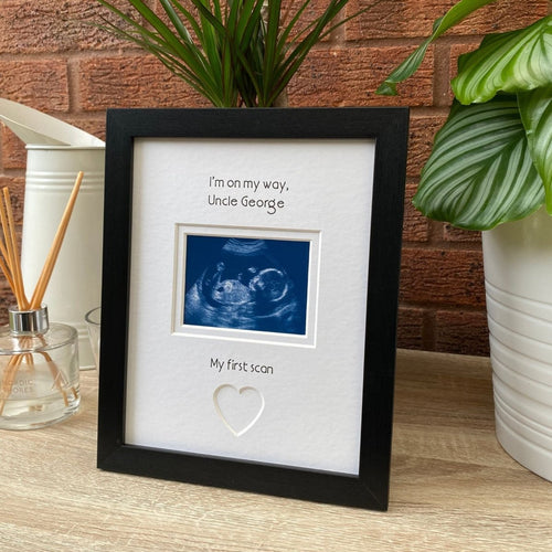 Black frame for Uncle to be on tabletop, next to a diffuser and plant