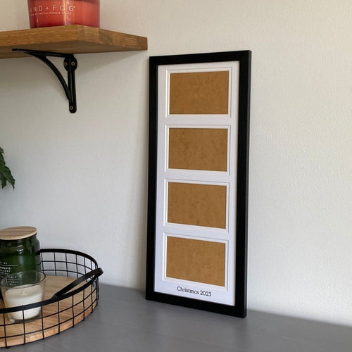 Black, multi aperture frame on grey dresser next to black mesh tray with candles and shelf , holds four landscape photographs - Azana Photo Frames
