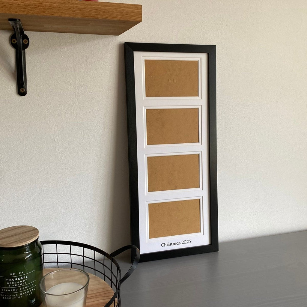 Black, multi aperture frame on grey dresser next to black mesh tray with candles and shelf , holds four landscape photographs - Azana Photo Frames