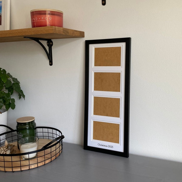 Black, multi aperture frame on grey dresser next to black mesh tray with candles and shelf , holds four landscape photographs - Azana Photo Frames
