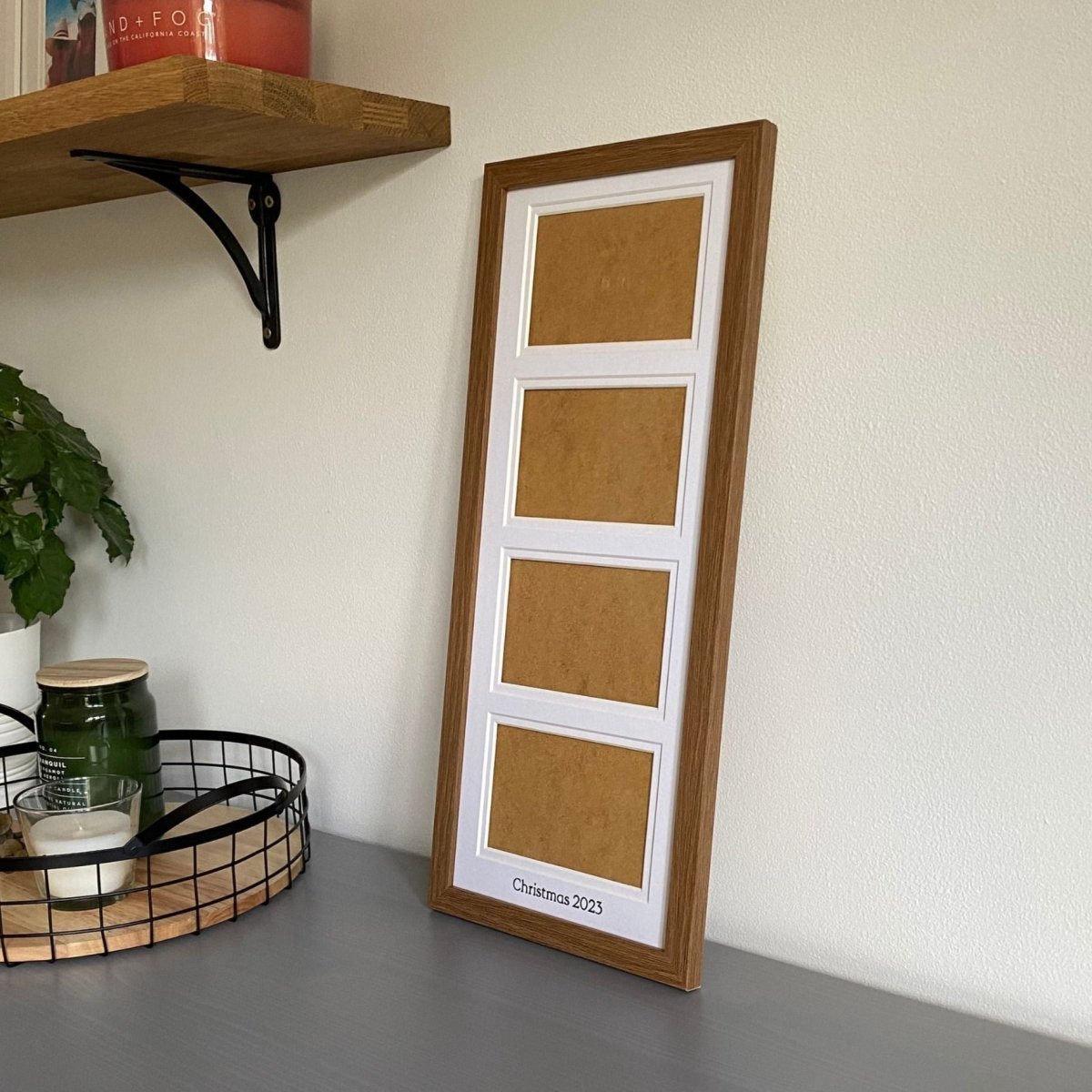 Dark brown frame with white mount on grey dresser next to a black mesh tray with candles and plant, shelf on wall - Azana Photo Frames