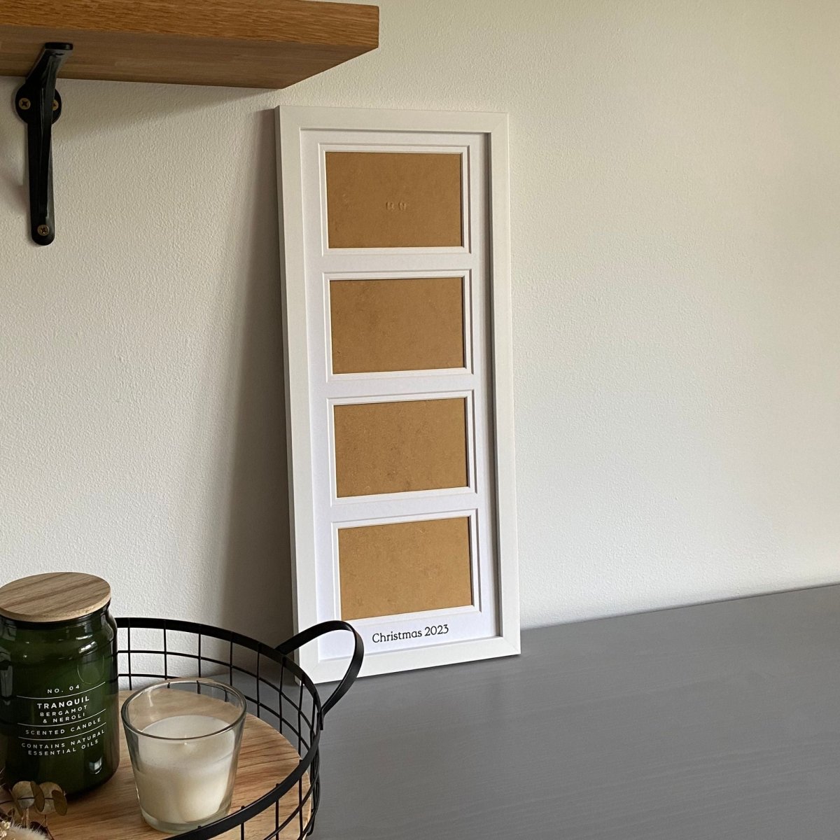 Multi Landscape Aperture Frame 4 Photos, White - holds four landscape photographs on grey tabletop next to black mesh tray with candles - Azana Photo Frames