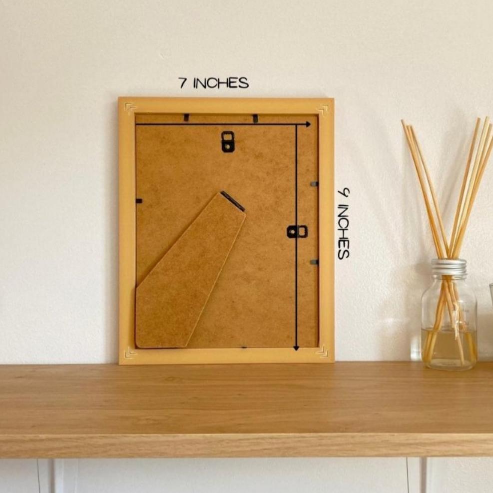 Back of a frame on the shelf next to a diffuser