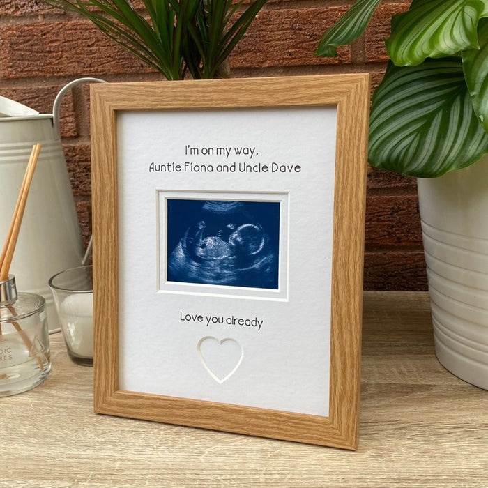 Freestanding baby scan picture frame on the tabletop, next to a candle, diffuser, jug and greenery plants