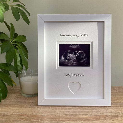 white contemporary first scan picture frame for Daddy, freestanding on the table top next to a white candle and plant
