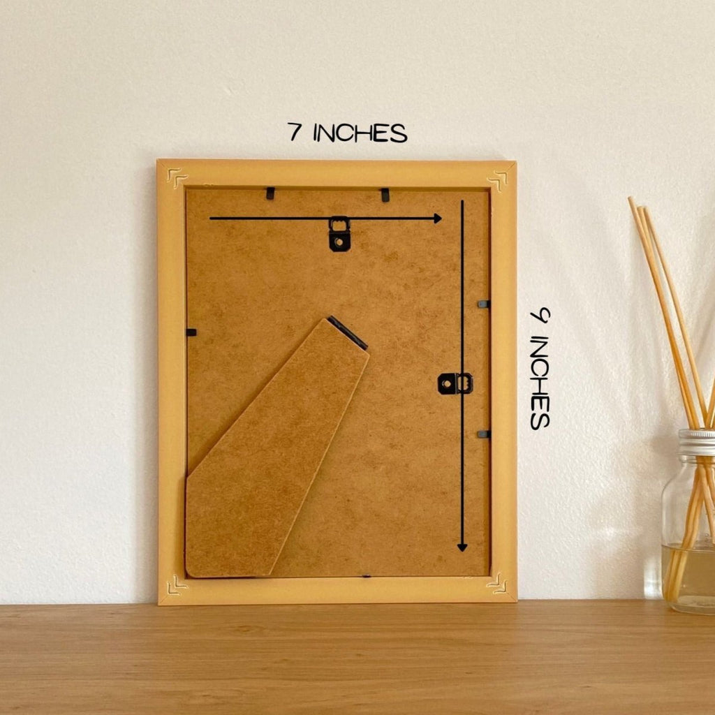 Size 9 x 7 inches picture frame resting on the shelf against the wall.