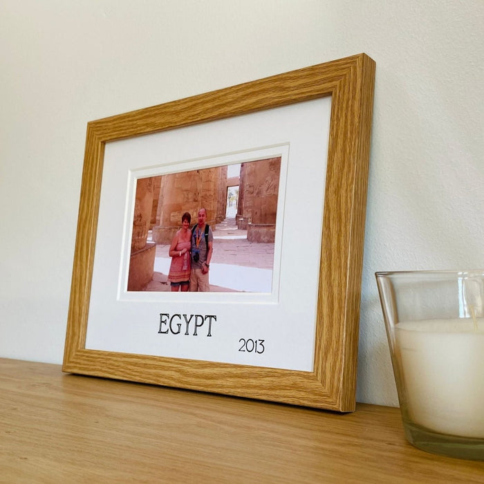 Egypt picture frame on a shelf next to a candle