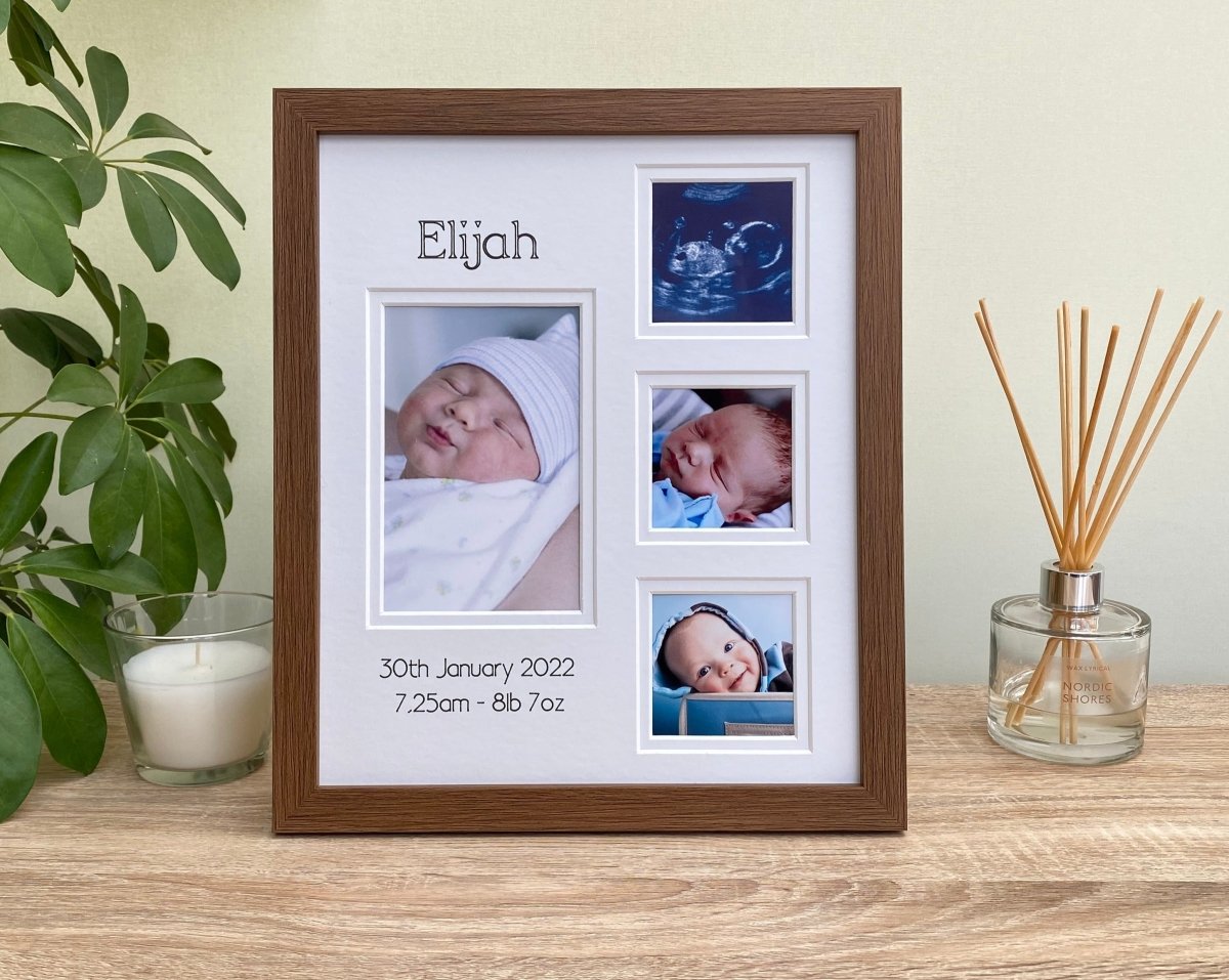 Baby Collage dark brown picture frame, freestanding on the tabletop next to a white candle, diffuser and green plant