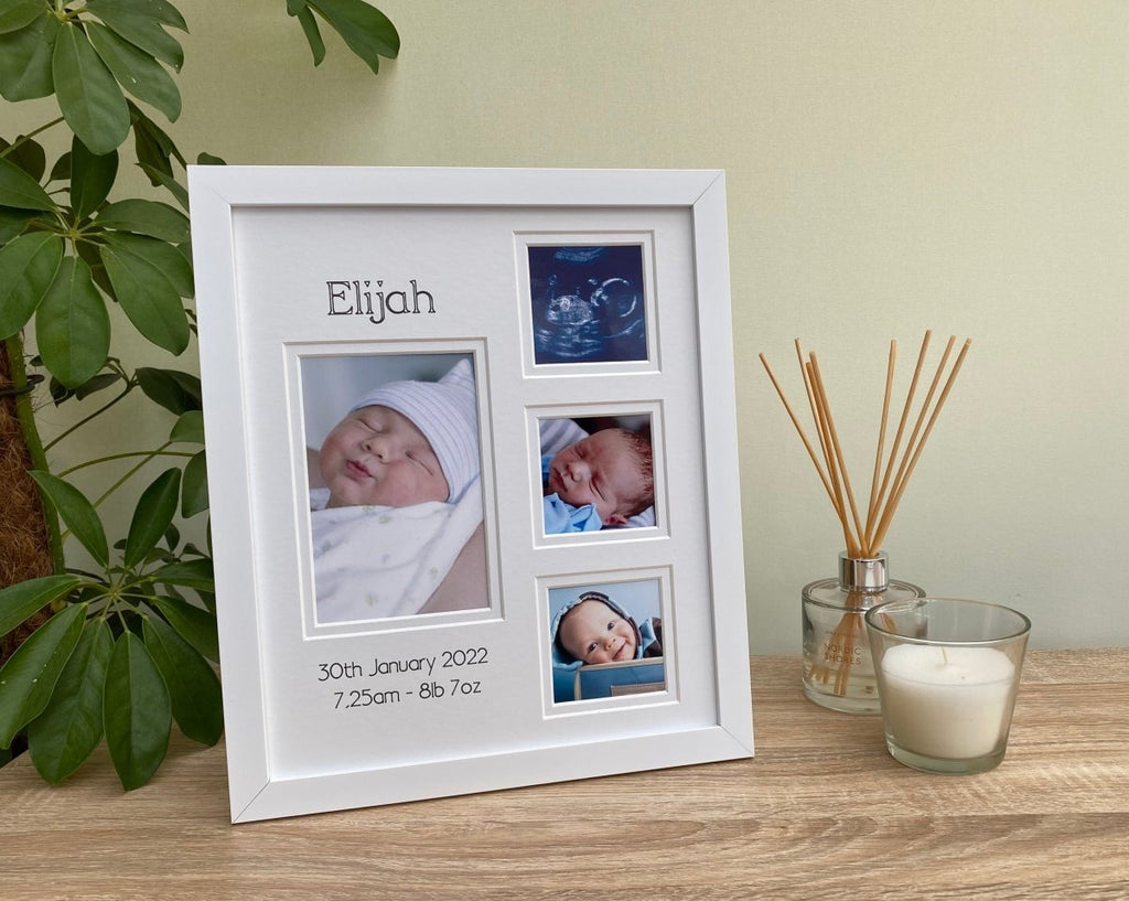 Baby Collage white modern picture frame, freestanding on the tabletop next to a white candle, diffuser and green plant