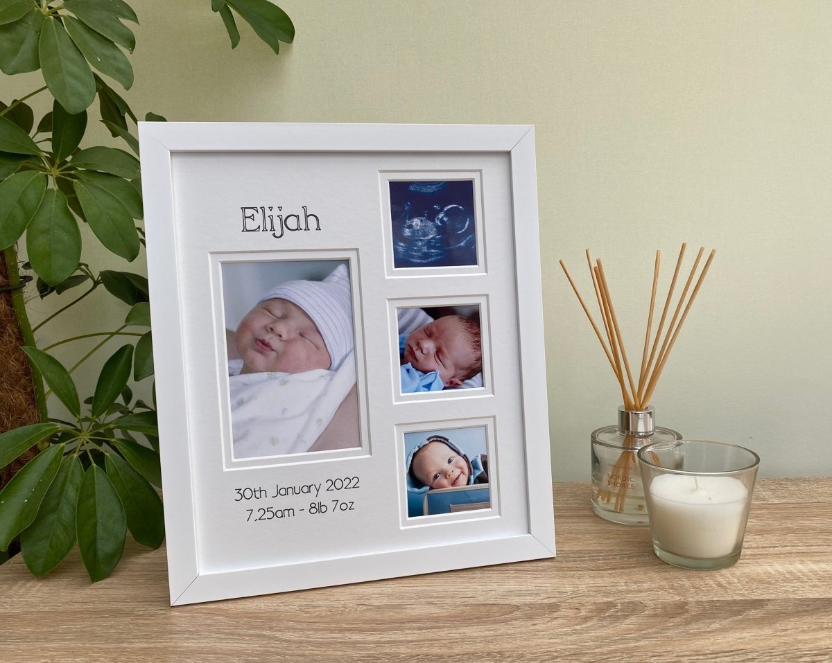 Baby Collage white modern picture frame, freestanding on the tabletop next to a white candle, diffuser and green plant