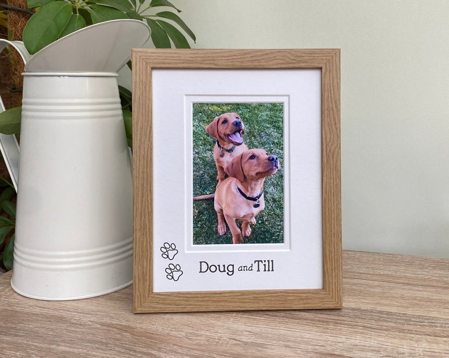Light brown Puppy Picture Frame next to a white jug and plant on tabletop