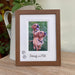 Dark brown picture frame, freestanding on the tabletop with a jug. Insert photo of any breeds, dogs or a pup