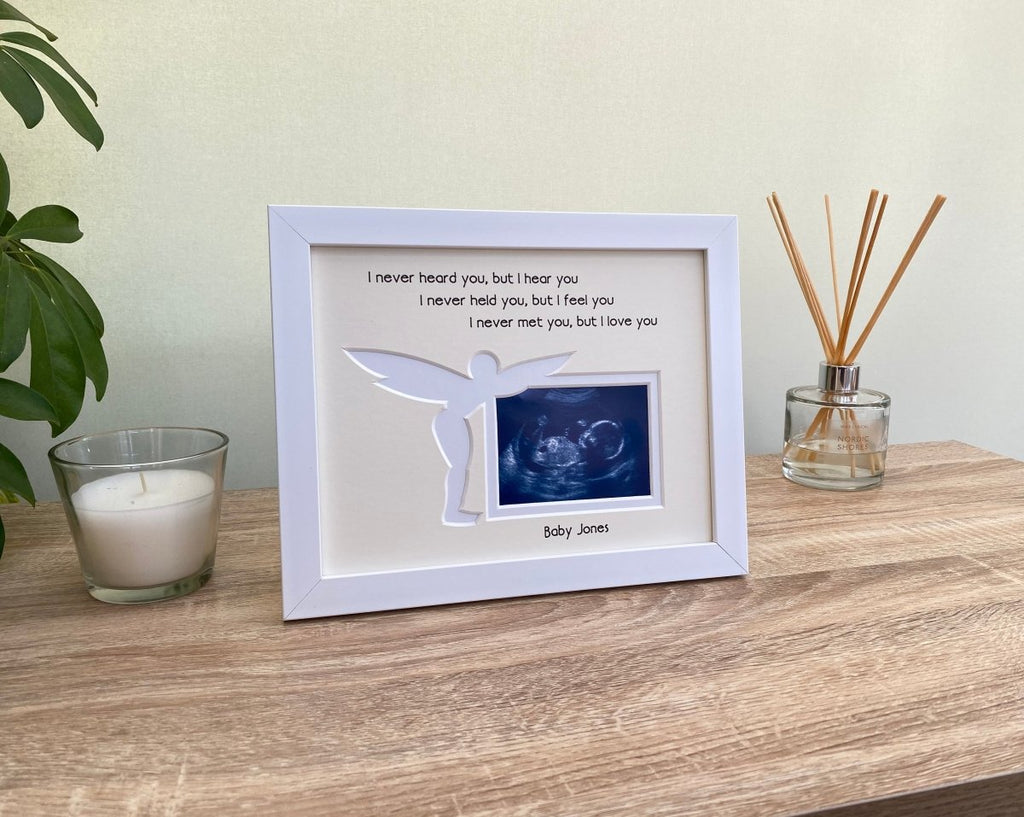 Fairy shaped pregnancy memory frame on strut back, freestanding with a diffuser, plant and a candle