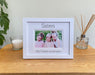 White picture frame, double white matted with Sisters and personalised with all the sister's names. Standing next to a white candle and diffuser on the table top with a plant on the side.