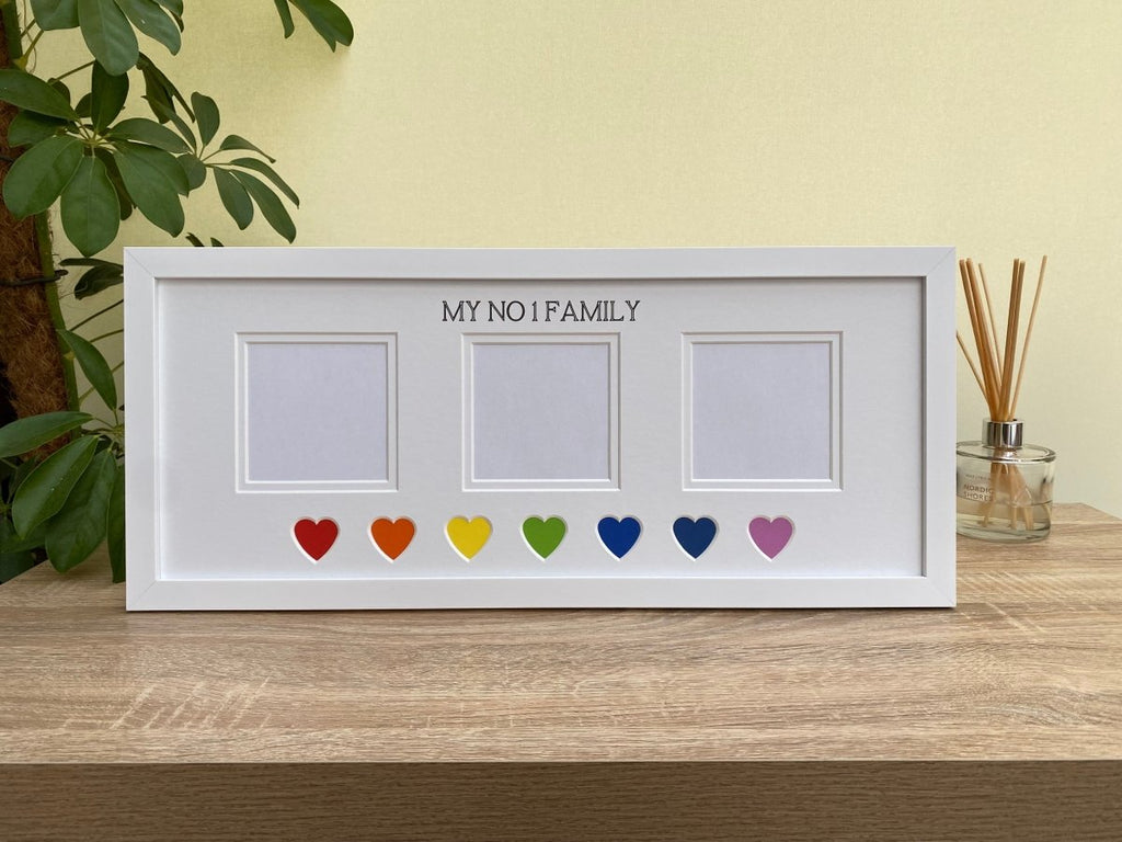 White picture frame, 'My No 1 Family' is inscribed at the top of the picture mount, colourful hearts