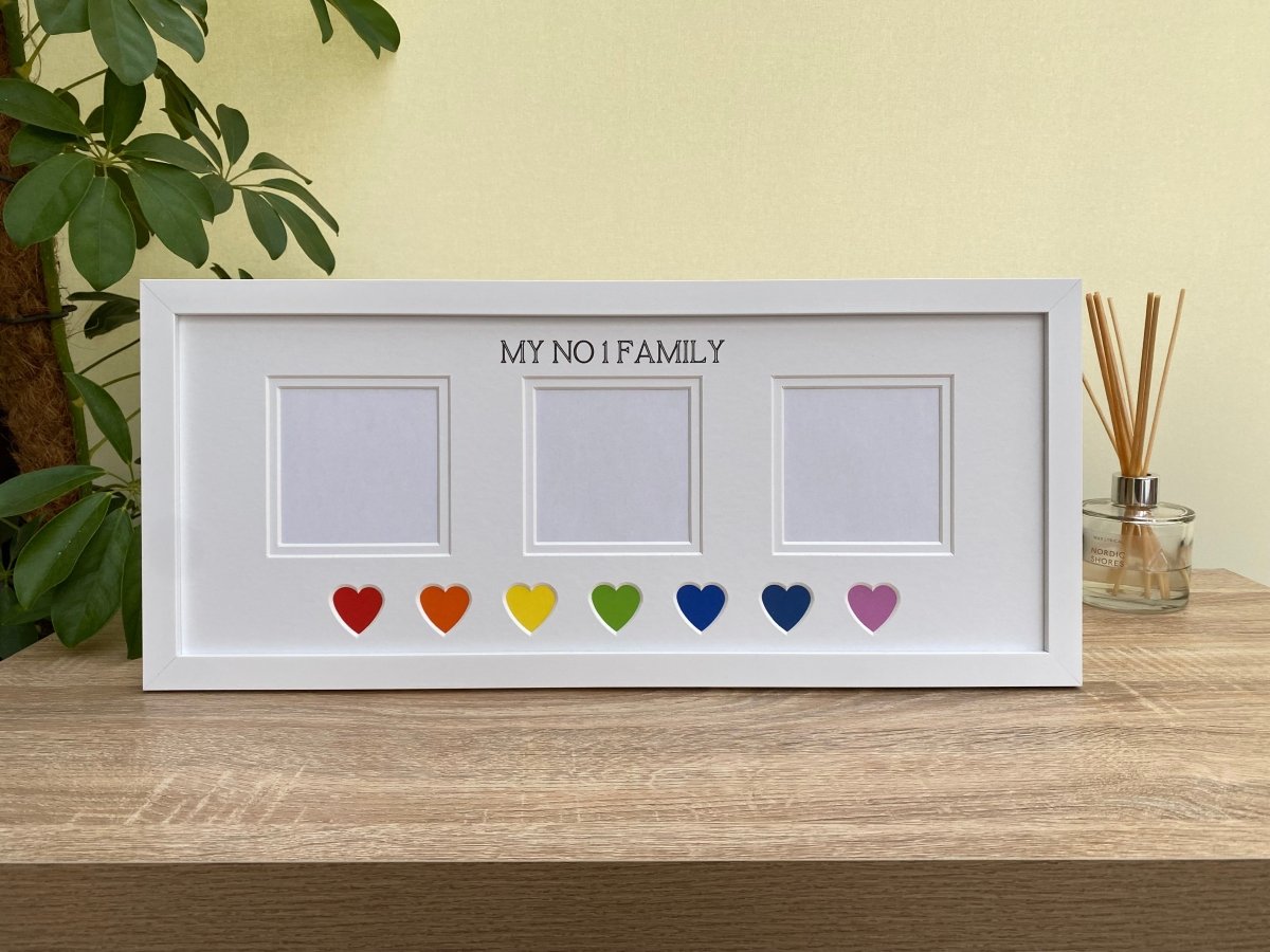 White picture frame, 'My No 1 Family' is inscribed at the top of the picture mount, colourful hearts