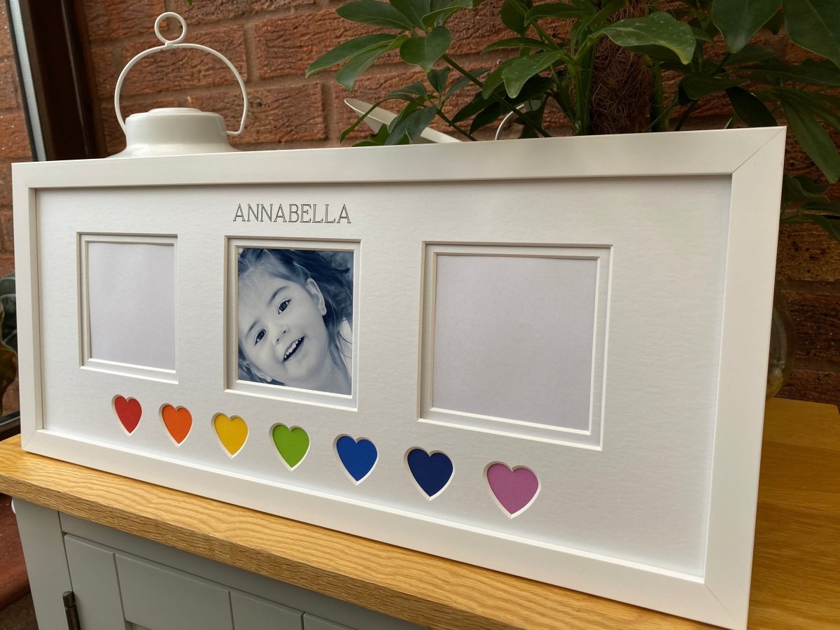 Colourful heart shaped displaying in an angle on the table top with a plant behind