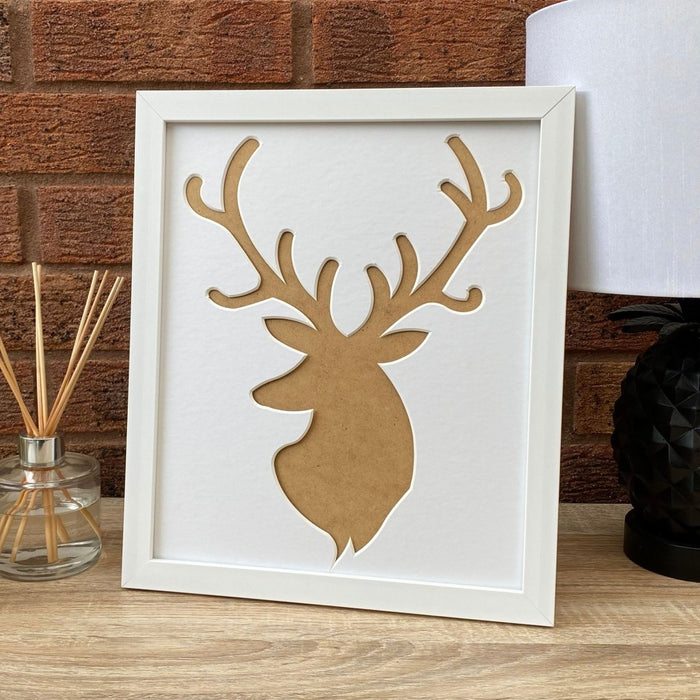 Stag white picture frame on table top next to a diffuser