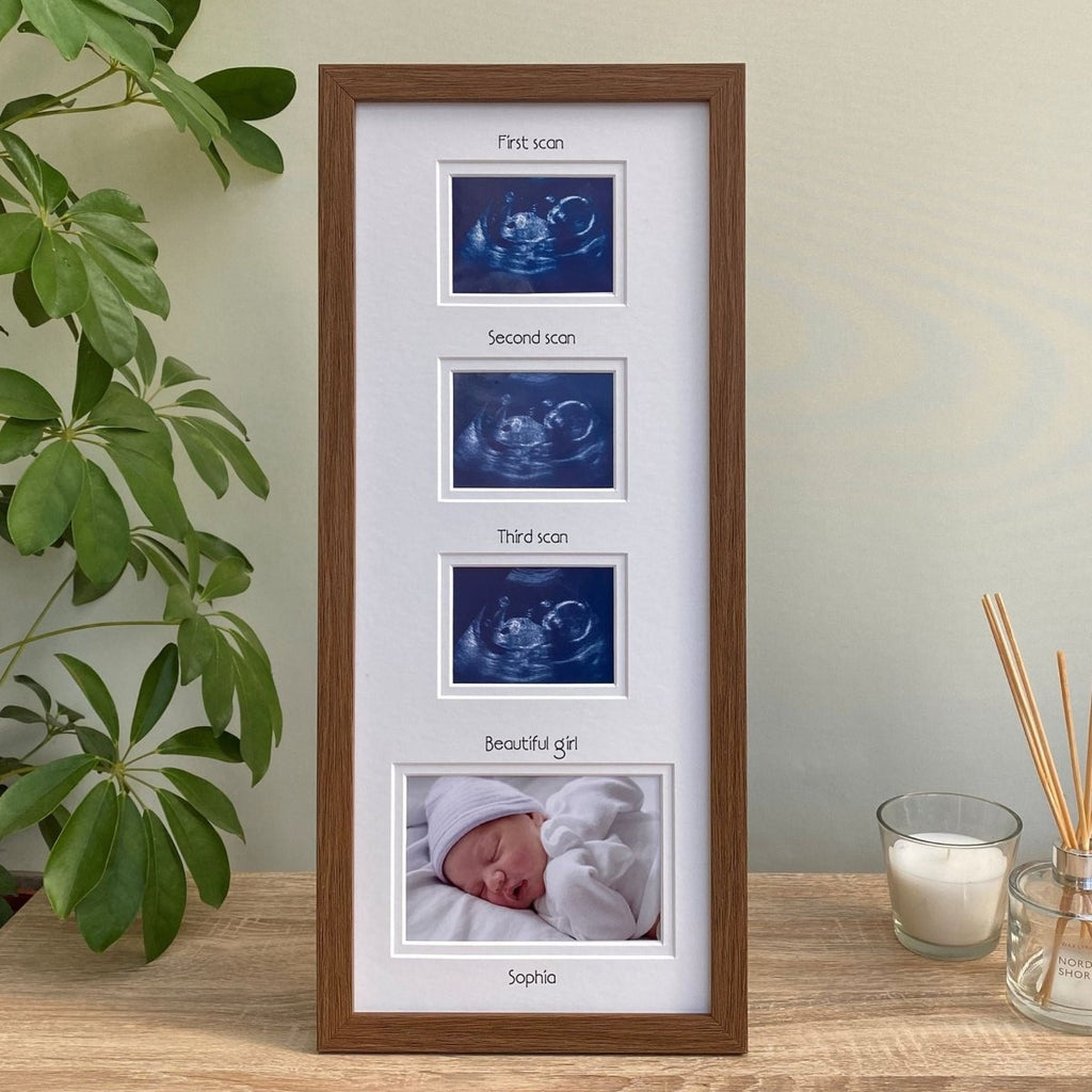 Dark brown, triple scan picture frame for girl on tabletop next to candle and plant