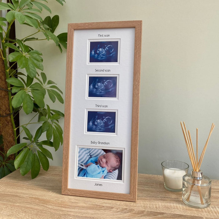 Light brown baby picture frame on tabletop next to a plant, diffuser and candle