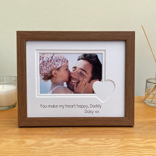 Wood-effect dark brown frame on the table top with the love heart shaped picture mount, a message for Daddy.